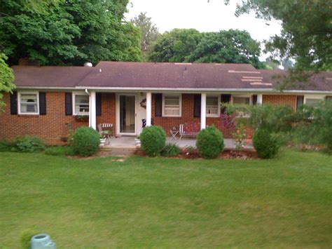 white brick ranch house with metal roof|metal roofed brick house.